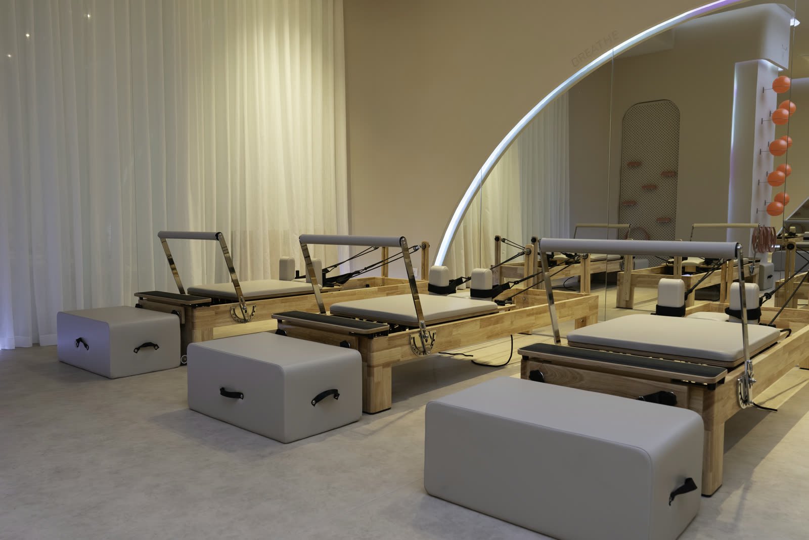 Wide view of the mirrored reformer Pilates floor at Studio 8, New Cairo