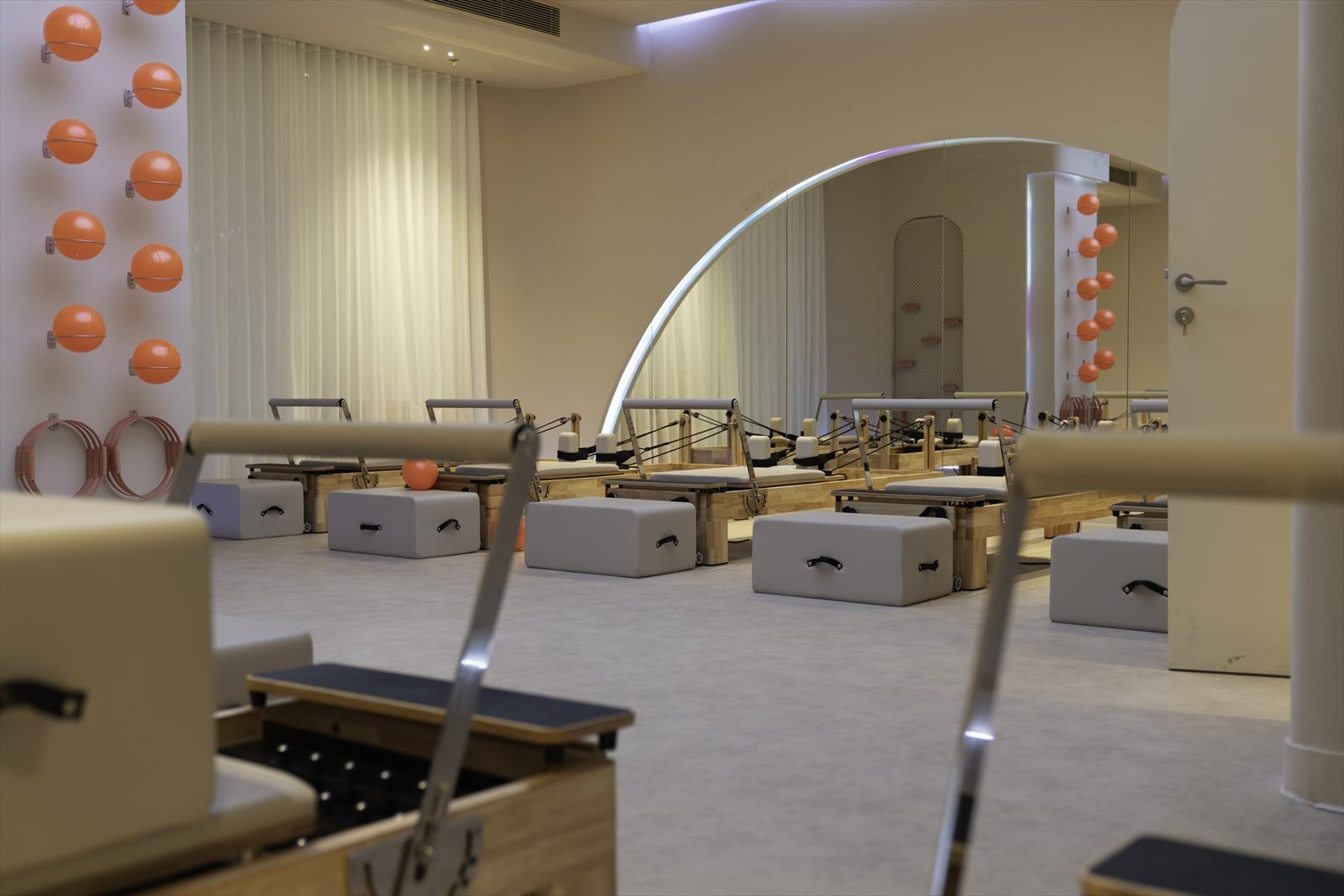 The reformer floor at Studio 8, a ladies-only Pilates studio in New Cairo, showing the row of machines