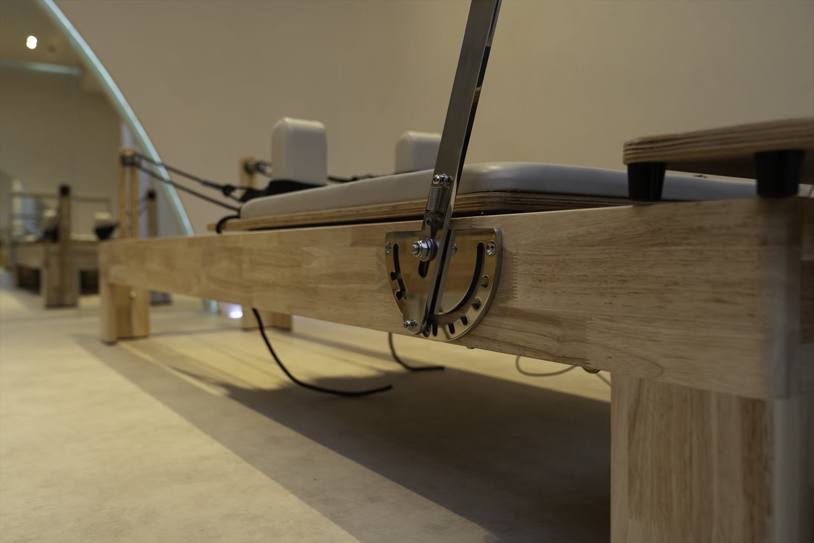 Close-up of new spring housing and footbar gear on a reformer at Studio 8